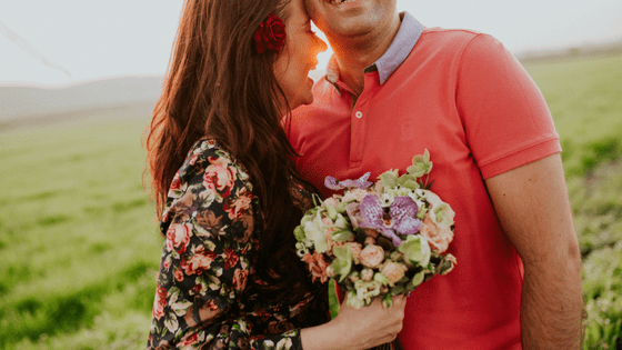 a man giving flowers to his date and making sure they're in odd number