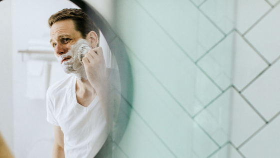 man shaving beard