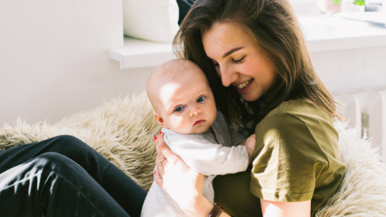 a woman holding a baby